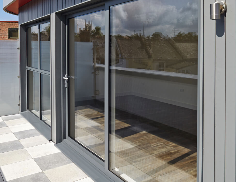A modern grey aluminium sliding patio door